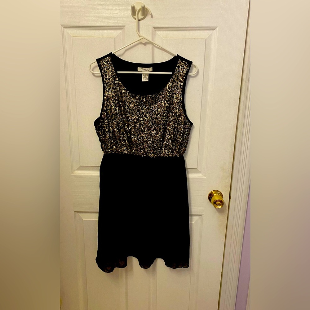 Black babydoll dress with metallic sequins.